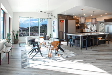 Open concept kitchen - large contemporary vinyl floor open concept kitchen idea in Phoenix with an undermount sink, flat-panel cabinets, black cabinets, quartz countertops, metallic backsplash, metal backsplash, stainless steel appliances, an island and white countertops