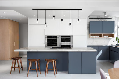Example of a large trendy l-shaped porcelain tile and white floor eat-in kitchen design in New York with a single-bowl sink, flat-panel cabinets, blue cabinets, white backsplash, stainless steel appliances and an island