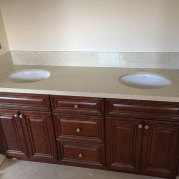 Antique Cherry glaze kitchen & bathroom cabinets and sparking Quartz countertops