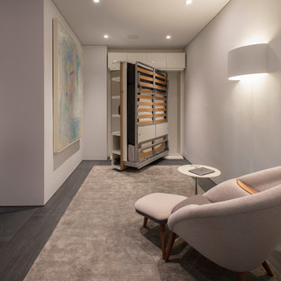 Design ideas for a modern study in DC Metro with porcelain flooring, a built-in desk and grey floors.