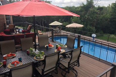 Design ideas for a backyard custom-shaped lap pool in Cedar Rapids with decking.