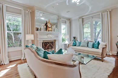 Inspiration for a large timeless formal and open concept medium tone wood floor and brown floor living room remodel in Dallas with beige walls, a standard fireplace, a wood fireplace surround and no tv