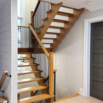 Modern White Oak Open Riser Staircase with Black Metal Balusters