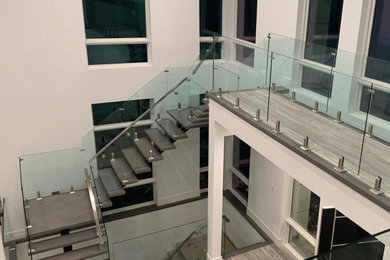 Inspiration for a modern glass railing staircase remodel in Toronto