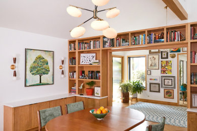 Large 1950s medium tone wood floor, brown floor and vaulted ceiling dining room photo in New York with white walls
