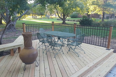 Design ideas for a mid-sized country backyard deck in Wichita with no cover.