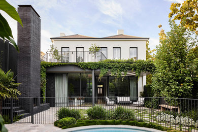 Inspiration for a large traditional two-storey brick white house exterior in Melbourne with a gable roof, a tile roof and a grey roof.