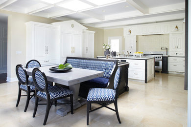 Enclosed kitchen - large transitional single-wall limestone floor enclosed kitchen idea in Chicago with a double-bowl sink, beaded inset cabinets, white cabinets, marble countertops, yellow backsplash, ceramic backsplash, paneled appliances and two islands