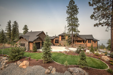 Large rustic brown three-story wood exterior home idea in Seattle
