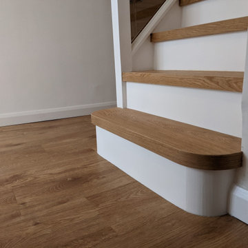 Engineered oak stair cladding with modern white painted risers, Epping Forest