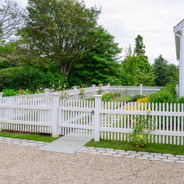 Cape Cod Home. Garden Path and White Picket Fence
