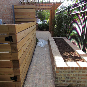 High function in a small side yard! Pergola, raised bed, mirrored wall, fountain
