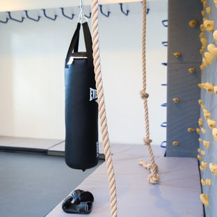 Photo of a medium sized modern home gym in New York with white walls.
