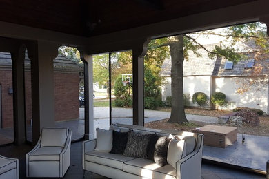 Photo of a mid-sized contemporary backyard screened-in verandah in Kansas City with tile and a roof extension.