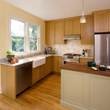 Shaker style kitchen cabinets with butcher block island counter