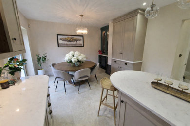 Modern kitchen/diner in Other with shaker cabinets, quartz worktops, an island and white worktops.