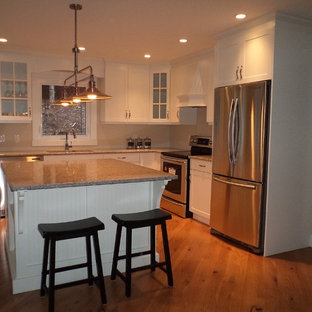 Mid-sized transitional kitchen pantry ideas - Mid-sized transitional l-shaped medium tone wood floor kitchen pantry photo in Toronto with a double-bowl sink, shaker cabinets, white cabinets, quartzite countertops, stainless steel appliances and an island