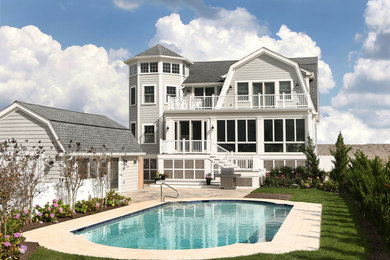 Design ideas for a large beach style two-storey grey exterior in Other with vinyl siding and a gable roof.