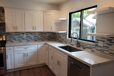 Example of a kitchen design in Los Angeles with shaker cabinets, white cabinets, quartzite countertops and white countertops