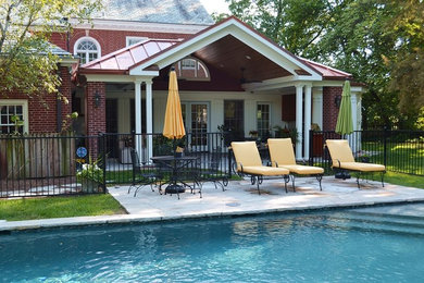 Design ideas for a mid-sized traditional backyard lap pool in St Louis with natural stone pavers and a pool house.