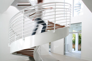 Inspiration for a contemporary wooden spiral staircase remodel in Miami