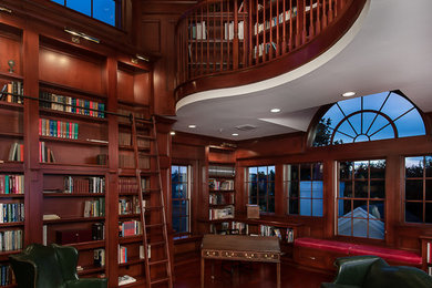 Study room - traditional freestanding desk medium tone wood floor study room idea in Orlando with brown walls