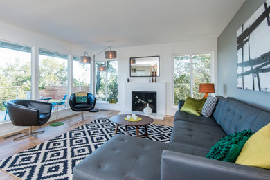 Living room - large modern open concept medium tone wood floor and brown floor living room idea in Nashville with white walls, a standard fireplace and a brick fireplace