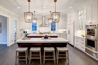 Enclosed kitchen - huge transitional l-shaped dark wood floor and brown floor enclosed kitchen idea in DC Metro with recessed-panel cabinets, white cabinets, granite countertops, gray backsplash, marble backsplash, paneled appliances, two islands and gray countertops
