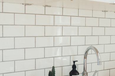 Inspiration for a large modern kitchen remodel in Los Angeles with a double-bowl sink, wood countertops, white backsplash, ceramic backsplash and white countertops