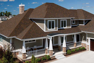 Imagen de fachada de casa marrón y marrón tradicional con tejado de teja de madera
