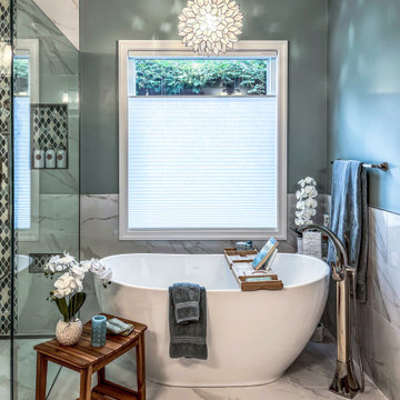 Primary Bath with Marble Look Tiled Shower and Free Standing Tub