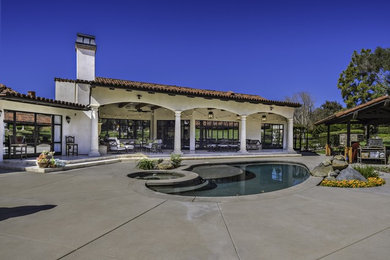 Large mountain style backyard patio photo in Austin