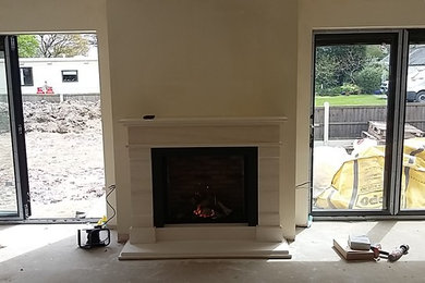Photo of a contemporary living room in Other with a standard fireplace and a stone fireplace surround.