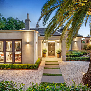 Inspiration for a large transitional beige house exterior in Melbourne with a hip roof and a tile roof.