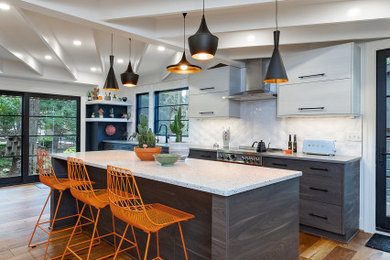 Large mid-century modern galley medium tone wood floor, brown floor and exposed beam eat-in kitchen photo in Detroit with a single-bowl sink, flat-panel cabinets, gray cabinets, quartz countertops, white backsplash, ceramic backsplash, colored appliances, an island and gray countertops