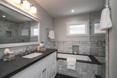 Mid-sized beach style master gray tile and marble tile porcelain tile and black floor bathroom photo in Other with shaker cabinets, white cabinets, an undermount tub, a one-piece toilet, gray walls, an undermount sink, soapstone countertops and black countertops