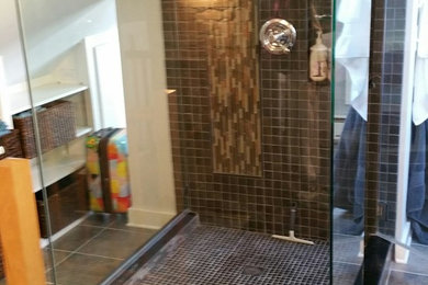 Example of a mid-sized urban master black tile, brown tile, gray tile and porcelain tile ceramic tile and gray floor alcove shower design in Minneapolis with white walls and a hinged shower door