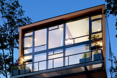 Photo of a mid-sized contemporary two-storey exterior in Seattle with a flat roof.