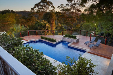Photo of a large contemporary backyard pool in Perth.
