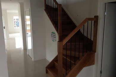 This is an example of a mid-sized modern painted wood u-shaped staircase in Brisbane with painted wood risers.