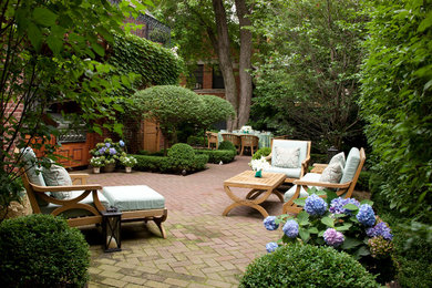 Photo of a mid-sized traditional backyard patio in Chicago with an outdoor kitchen, brick pavers and no cover.
