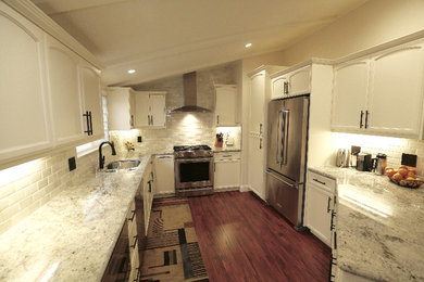 Mid-sized elegant u-shaped dark wood floor and brown floor kitchen pantry photo in San Francisco with an undermount sink, recessed-panel cabinets, white cabinets, granite countertops, white backsplash, subway tile backsplash, stainless steel appliances and no island