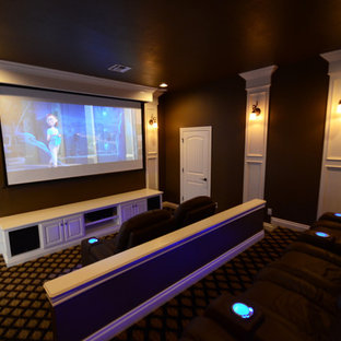 Home theater - large traditional enclosed carpeted home theater idea in Oklahoma City with brown walls and a projector screen