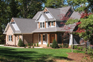 Large two-story brick exterior home photo in Charlotte