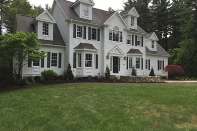 Mid-sized elegant white two-story vinyl gable roof photo in Boston
