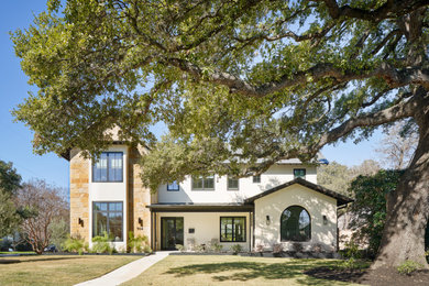Stone gable roof idea in Austin with a metal roof and a brown roof