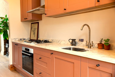 This is an example of a medium sized traditional kitchen in London.