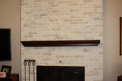 Traditional living room in Boston with a brick fireplace surround.