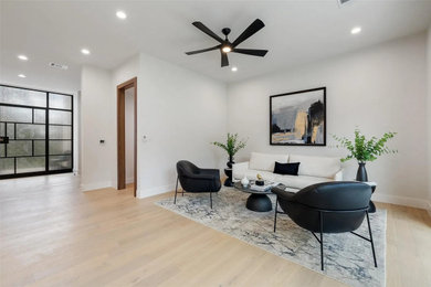 Inspiration for a large contemporary formal and open concept light wood floor, beige floor, tray ceiling and wall paneling living room remodel in Other with white walls, no fireplace and no tv