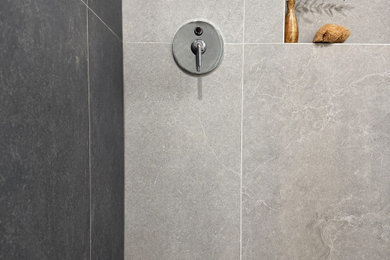 Walk-in shower - small modern 3/4 ceramic tile, gray floor and single-sink walk-in shower idea in Los Angeles with flat-panel cabinets, blue cabinets, a one-piece toilet, white walls, an undermount sink, quartz countertops, a hinged shower door, white countertops, a niche and a built-in vanity